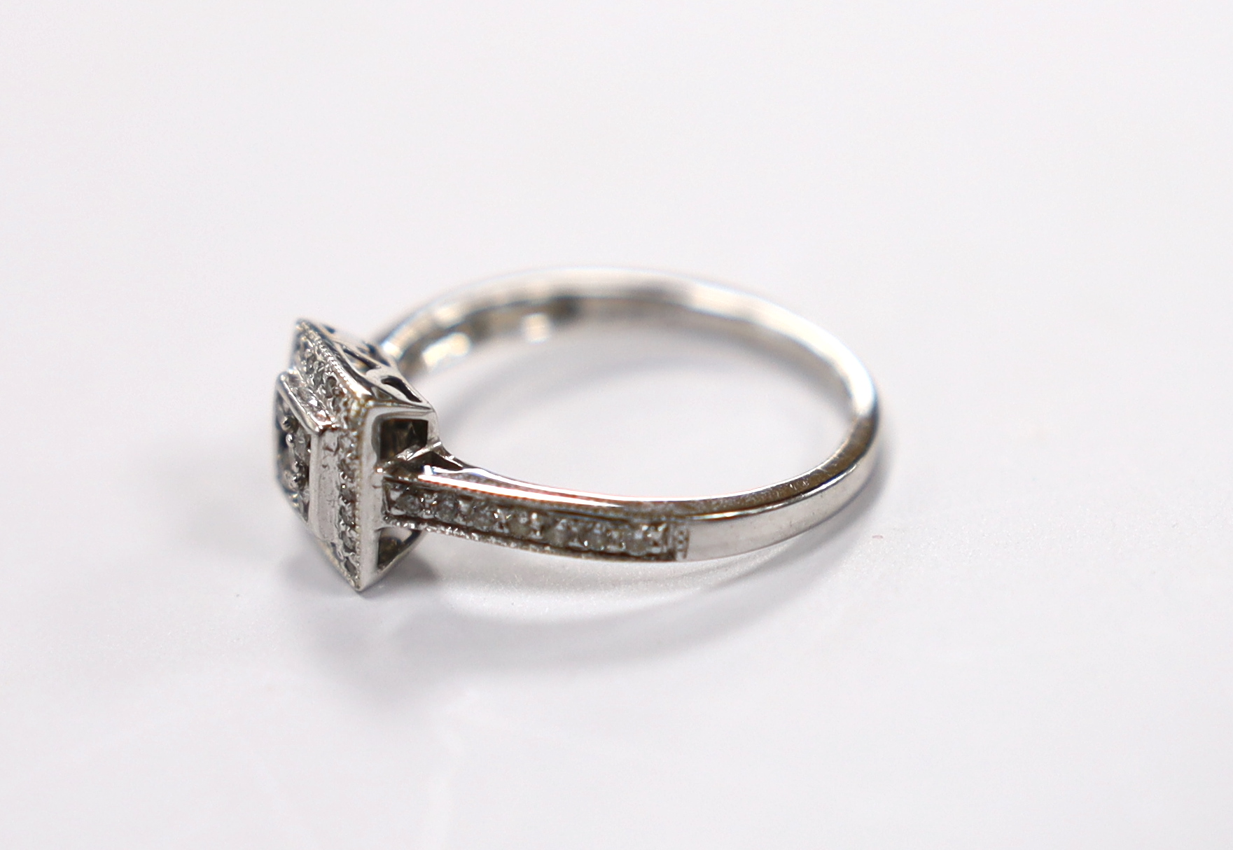 A modern 18ct white gold and diamond cluster set tablet ring, size J, gross weight 2.3 grams.